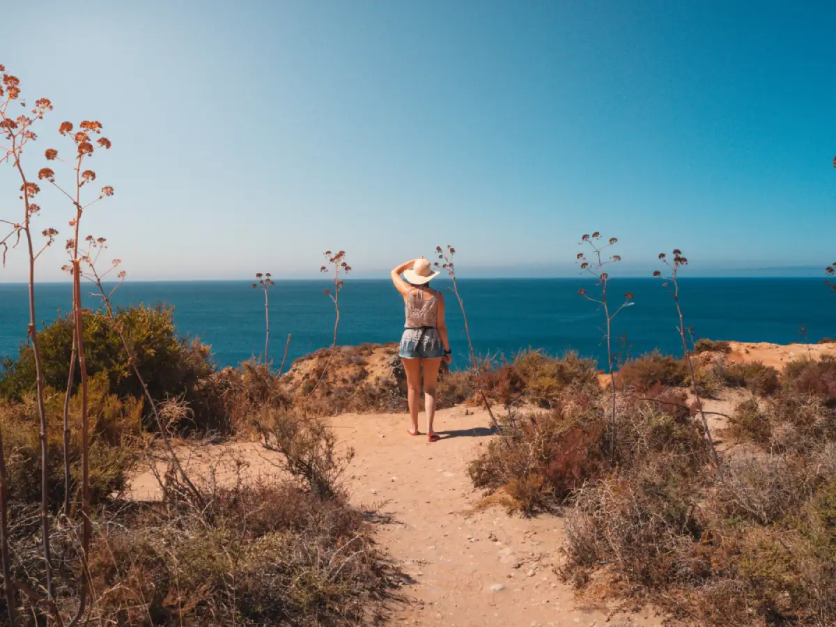 Australian beach during summer with people enjoying the sun, representing seasonal habits that can impact oral health.