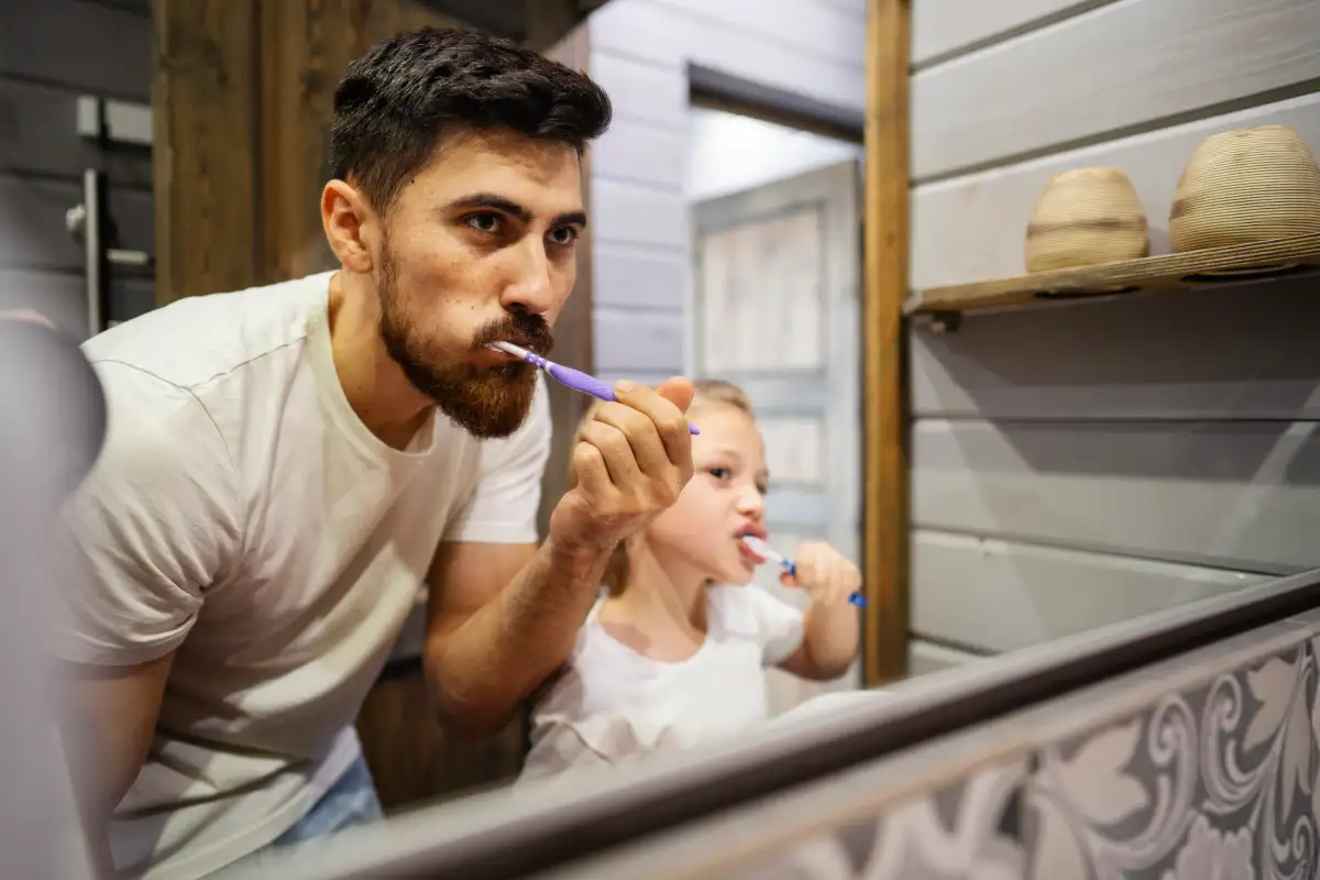 A frustrated toddler refusing to brush their teeth during the bedtime routine, illustrating the common "brushing battle" discussed by Maroubra dentist Dr. Roxanne Irani.